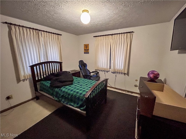 carpeted bedroom featuring a textured ceiling