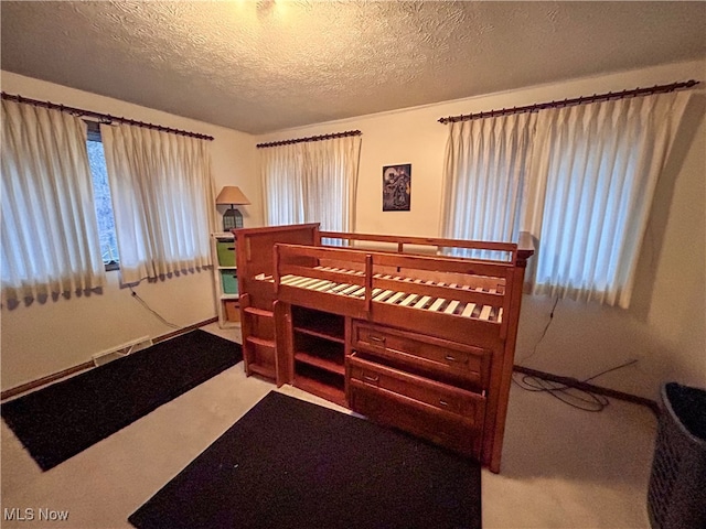 carpeted bedroom with a textured ceiling