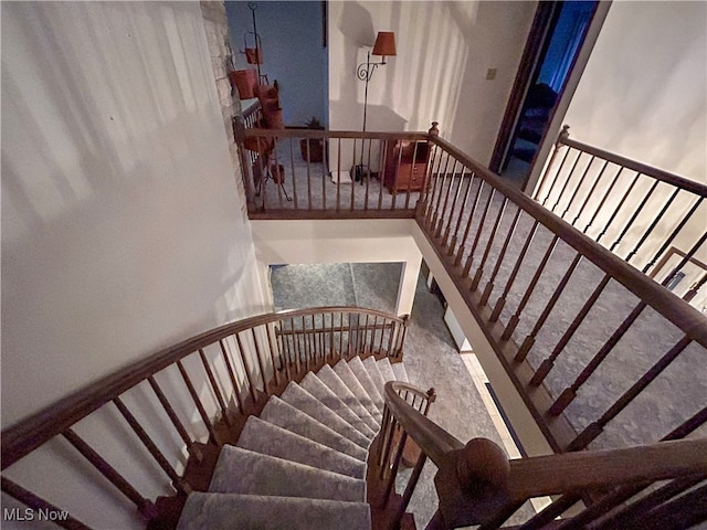 stairs featuring a high ceiling