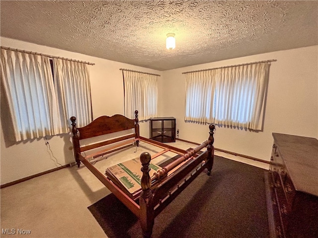 bedroom with carpet and a textured ceiling