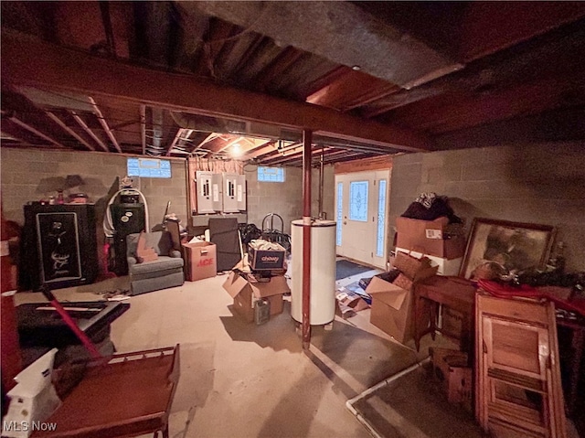 basement featuring electric panel and water heater