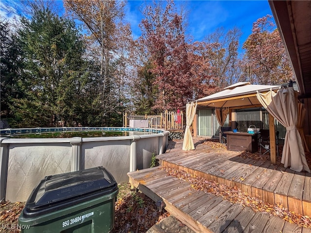 wooden terrace featuring a gazebo