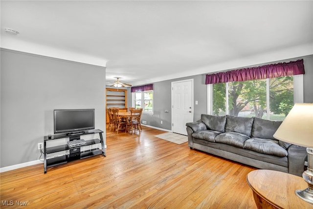 living room with light hardwood / wood-style floors and ceiling fan