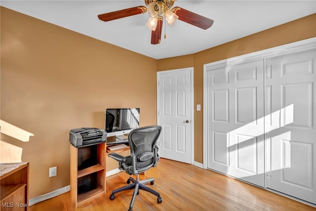 office with light hardwood / wood-style floors and ceiling fan