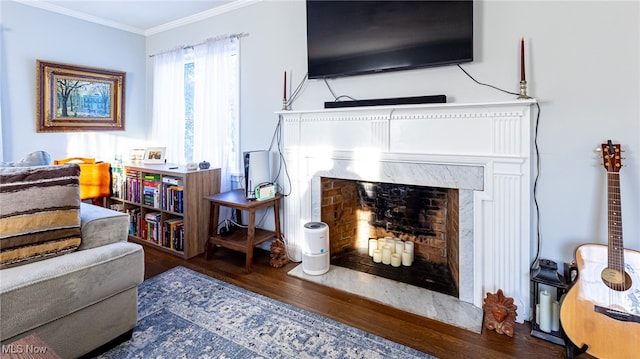 living room with crown molding, dark hardwood / wood-style flooring, and a high end fireplace