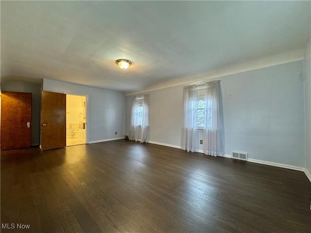 empty room featuring dark hardwood / wood-style flooring