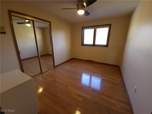 7596 W 130th St, Middleburg Heights, OH 44130 - unfurnished bedroom featuring a closet, hardwood / wood-style floors, and ceiling fan