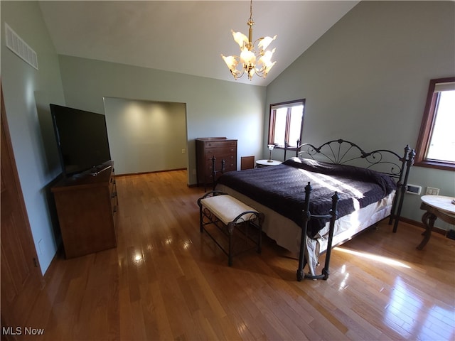 7596 W 130th St, Middleburg Heights, OH 44130 - bedroom with wood-type flooring, high vaulted ceiling, and a notable chandelier