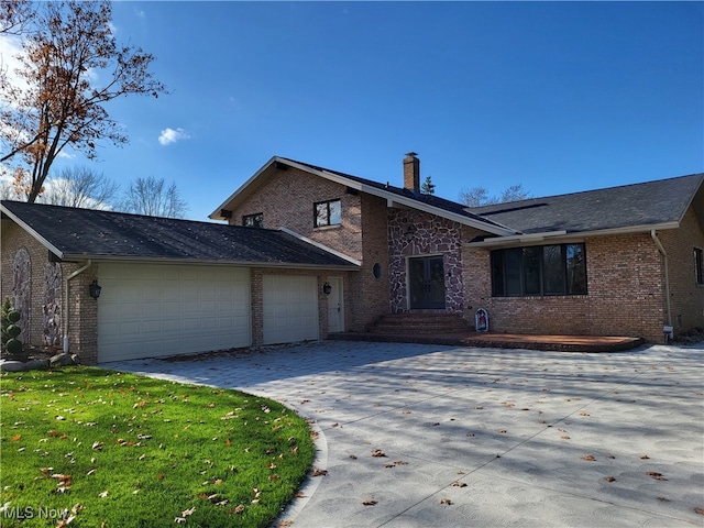 view of front of home with a garage and a front lawn