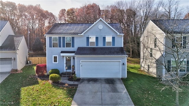 front of property with a front lawn, a garage, and cooling unit