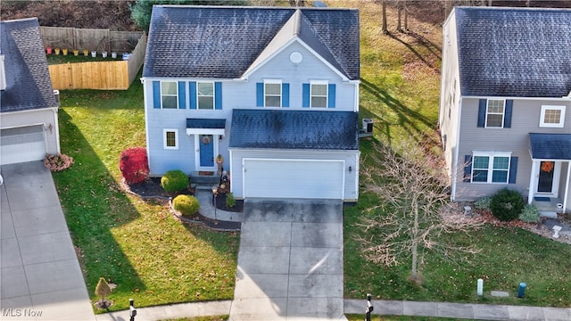 front facade with a garage and a front lawn