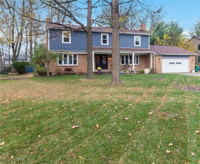 front facade featuring a garage, a front yard, and a porch