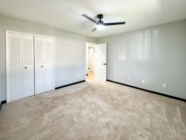 unfurnished bedroom with ceiling fan and light carpet