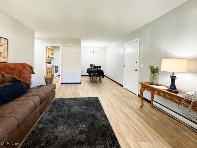 living room featuring wood-type flooring and an inviting chandelier