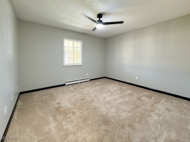 carpeted empty room featuring baseboard heating, a textured ceiling, and ceiling fan