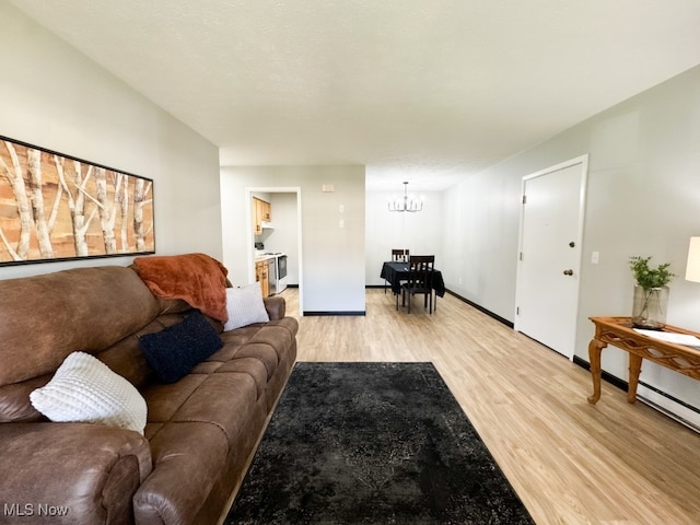 living room with light hardwood / wood-style flooring and a chandelier