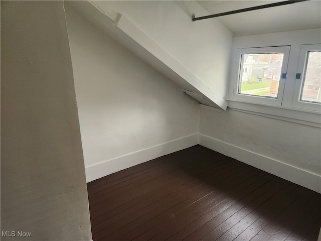 bonus room with dark wood-type flooring