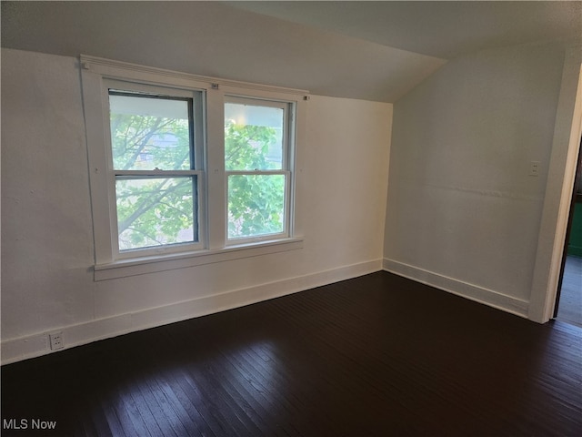 bonus room featuring dark hardwood / wood-style flooring and vaulted ceiling