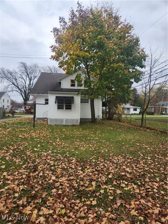 rear view of house with a yard