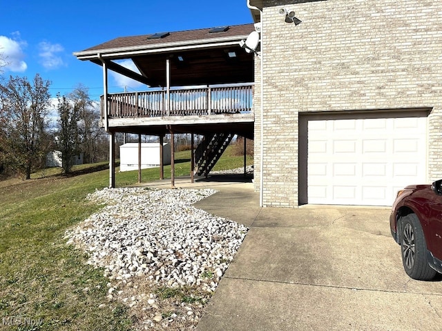 exterior space with a garage, a wooden deck, and a lawn