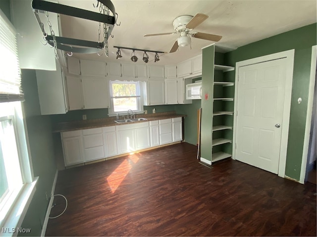 kitchen featuring ceiling fan, dark hardwood / wood-style floors, white cabinetry, and sink