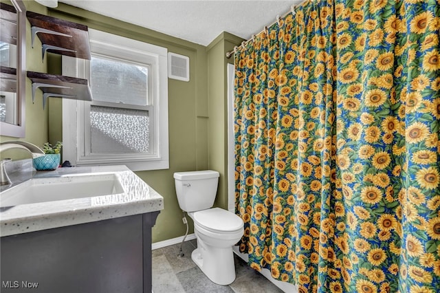 bathroom featuring vanity, a textured ceiling, and toilet