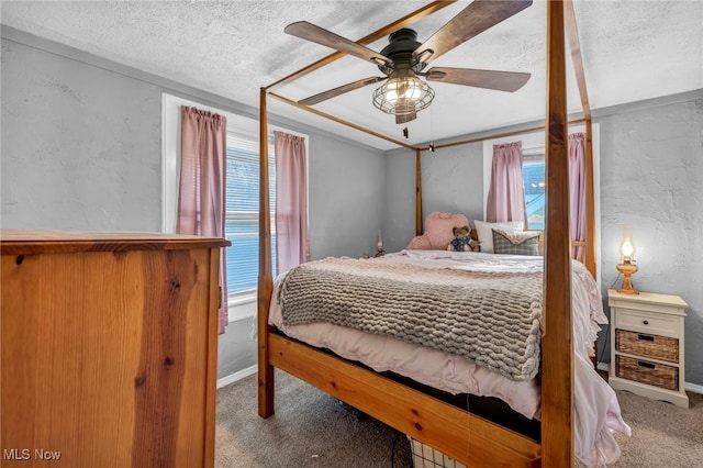 carpeted bedroom featuring ceiling fan and a textured ceiling