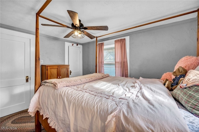 bedroom with ceiling fan and ornamental molding