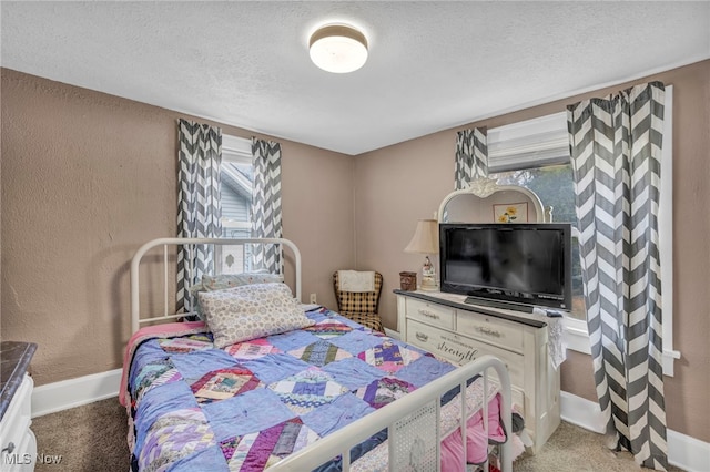 carpeted bedroom featuring a textured ceiling