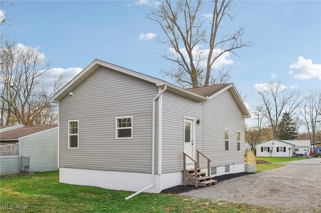 view of side of property featuring a yard