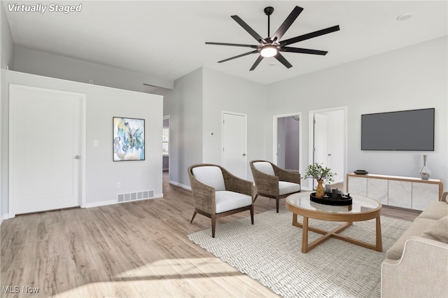 living room featuring light wood-type flooring and ceiling fan