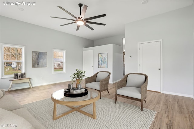 living area featuring ceiling fan and light hardwood / wood-style flooring