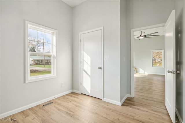 foyer entrance with light wood-type flooring and ceiling fan