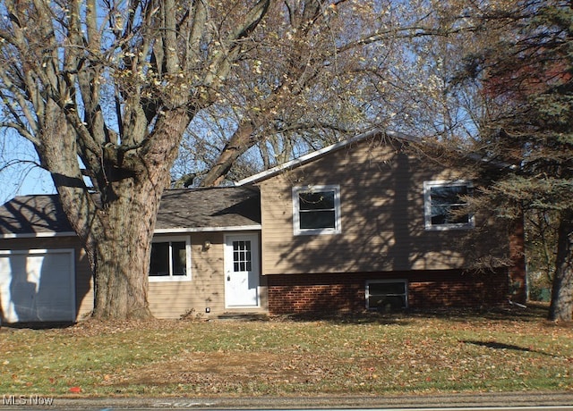 split level home featuring a garage and a front yard