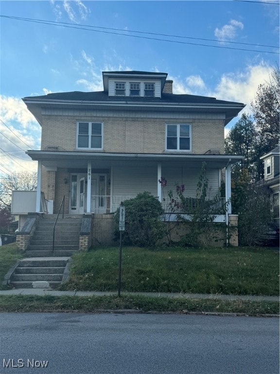 view of front of house with a porch and a front yard