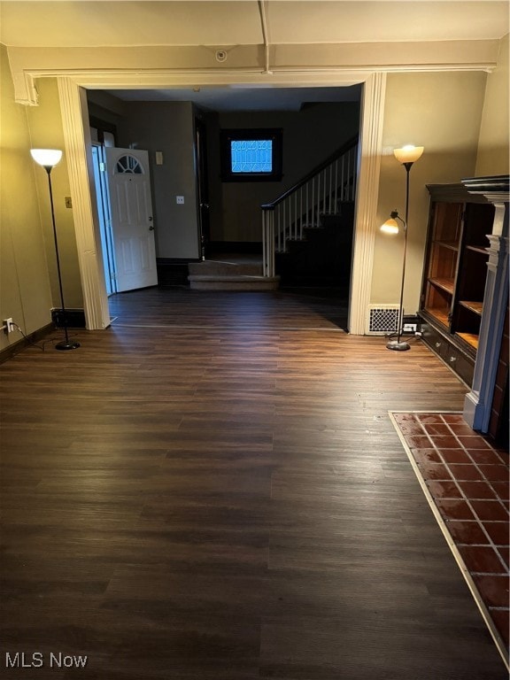 unfurnished living room featuring dark hardwood / wood-style flooring