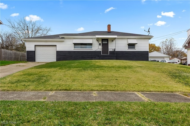 ranch-style home with a front yard and a garage