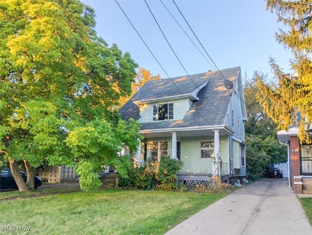 bungalow-style home with covered porch and a front yard