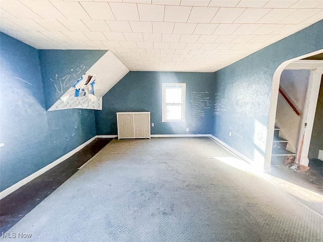 bonus room with lofted ceiling, carpet floors, and radiator