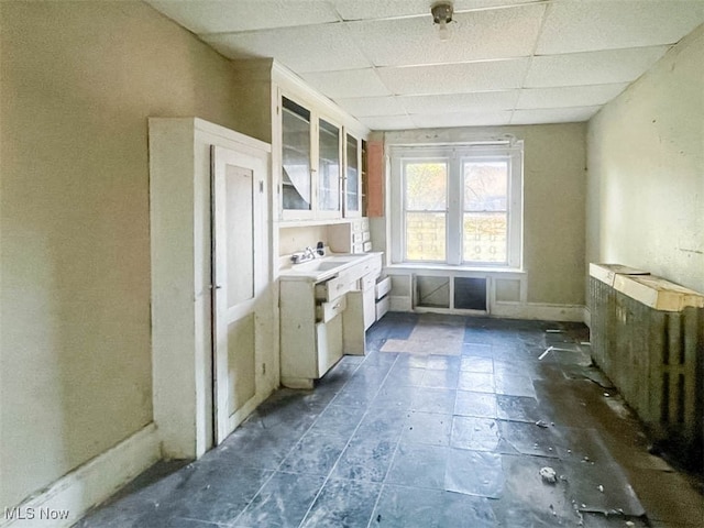 kitchen featuring a drop ceiling and sink