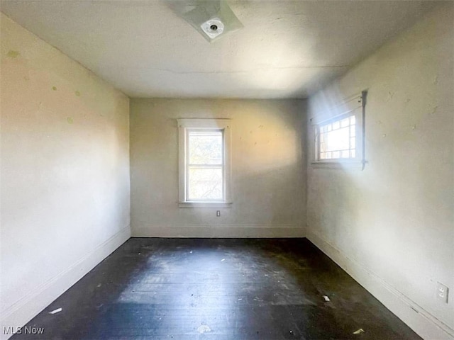 unfurnished room featuring dark hardwood / wood-style floors