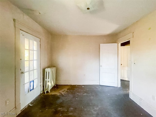 empty room featuring a healthy amount of sunlight and radiator