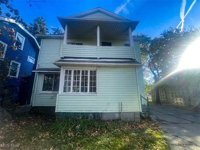 back of house with a balcony