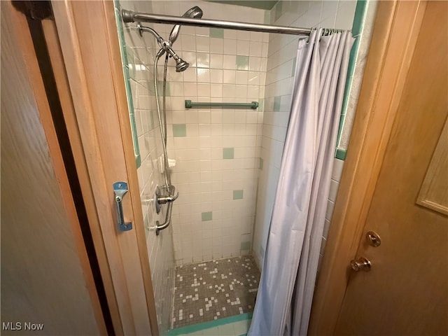 bathroom with walk in shower and tile patterned flooring