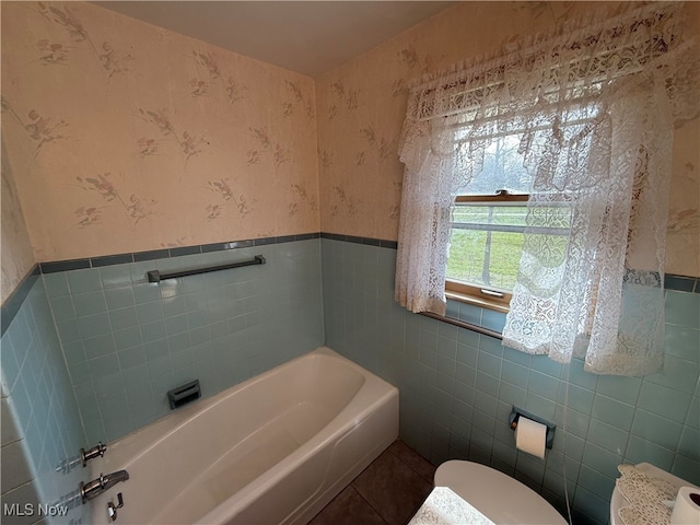 bathroom with a bath and tile walls