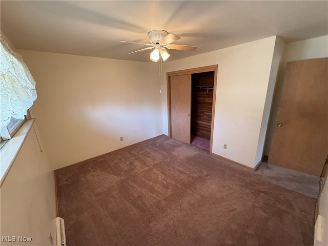 unfurnished bedroom with ceiling fan, a closet, and carpet