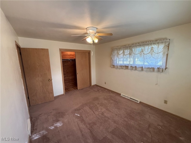 unfurnished bedroom with carpet flooring, ceiling fan, and a baseboard heating unit