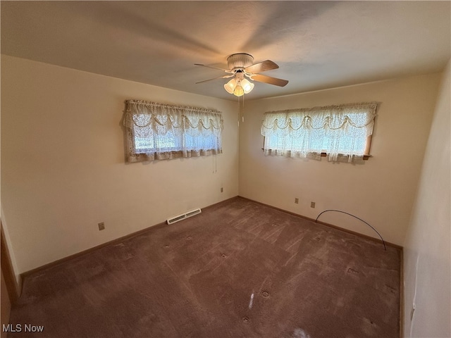 unfurnished room featuring ceiling fan and carpet