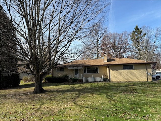 rear view of house with a lawn