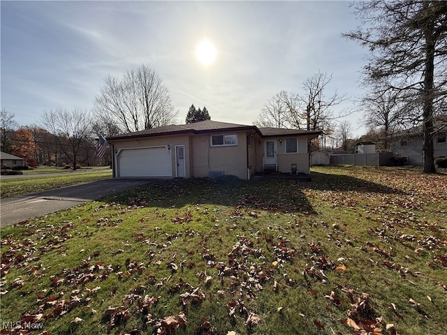 view of home's exterior featuring a garage and a yard